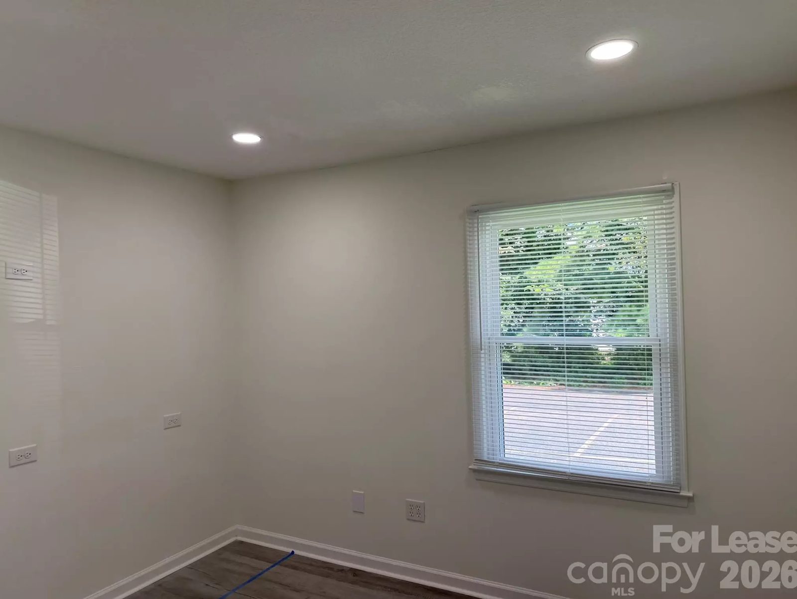 Bright neutral office suite with window overlooking parking, Denver NC