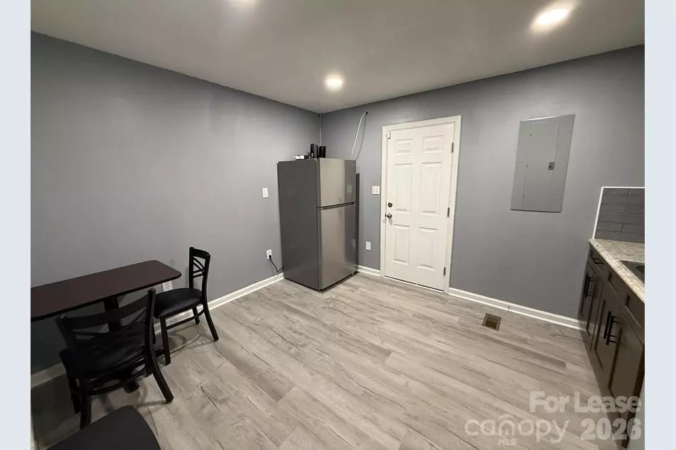 Breakroom with table, chairs and full-size refrigerator for tenants