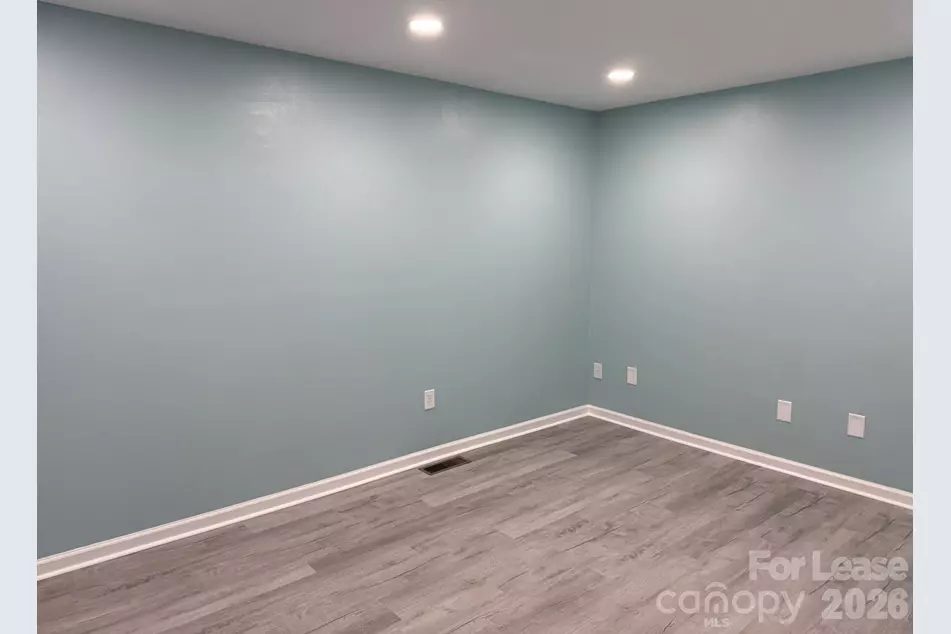 Open office suite with fresh paint and recessed lighting ready for move-in