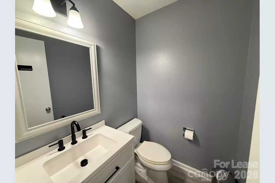 Second shared restroom with vanity and mirror